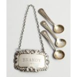 A SILVER BRANDY LABEL AND THREE SALT SPOONS