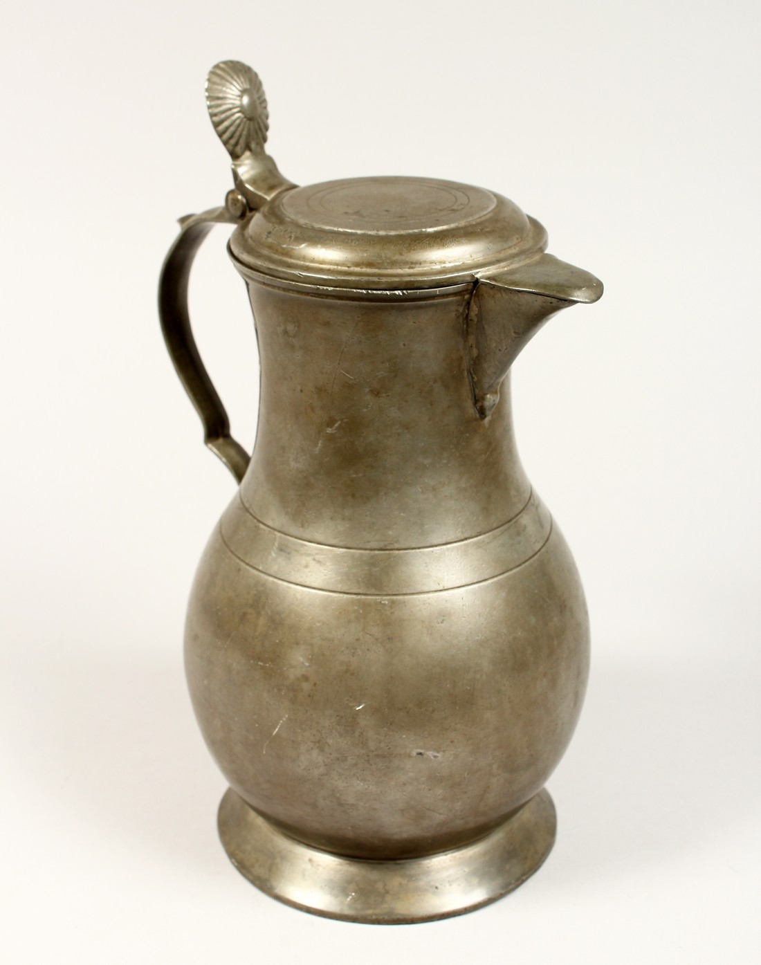 A FRENCH PEWTER LIDDED JUG 10ins high.
