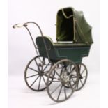 A RARE VICTORIAN METAL, WOOD AND LEATHER PRAM with folding hood, porcelain handles, wooden wheels.