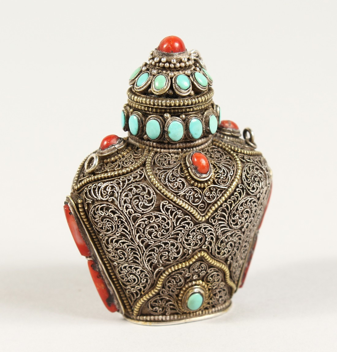 AN ISLAMIC FILIGREE SILVER SCENT BOTTLE with coral and turquoise stones. 2.5ins