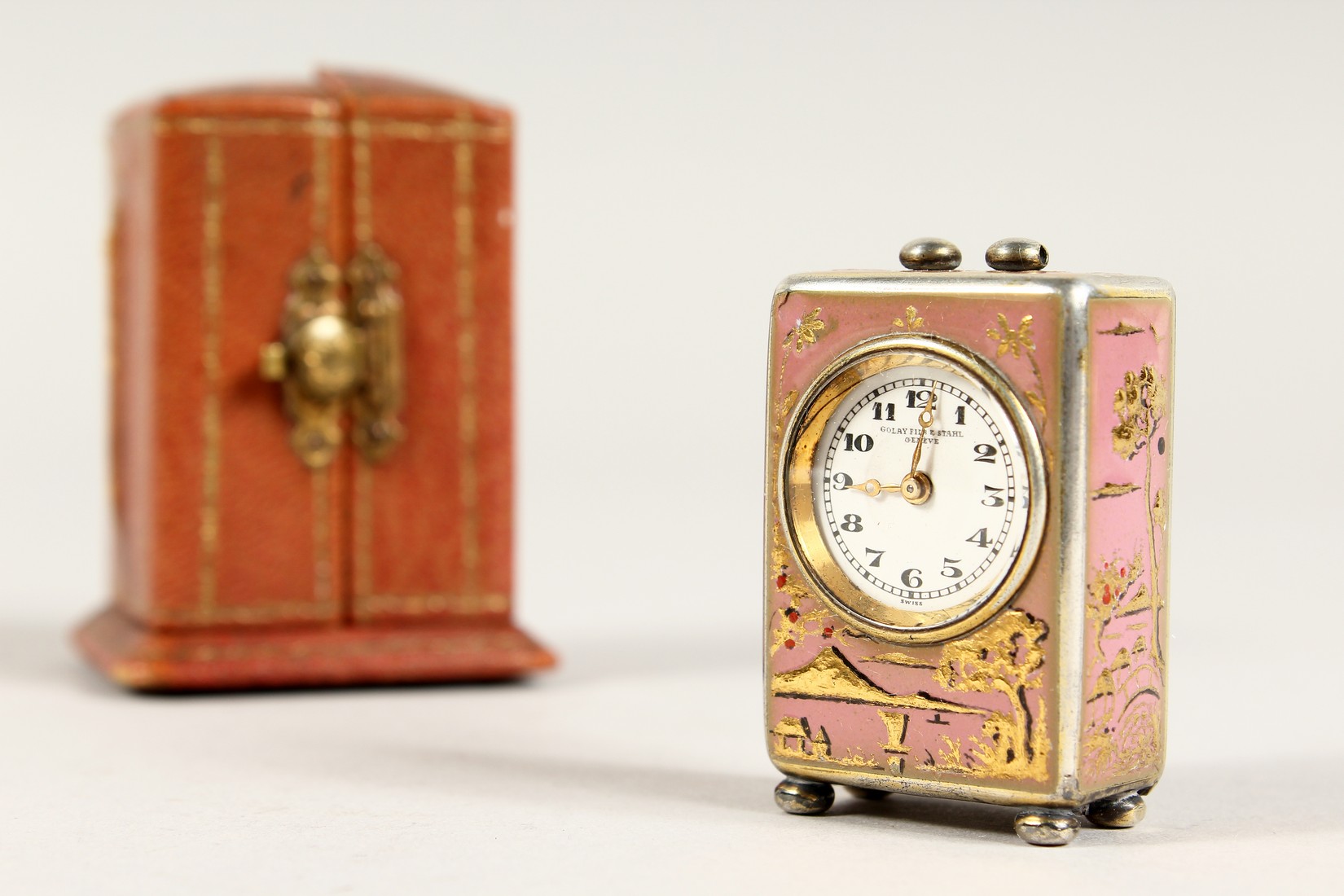 A SUPERB SMALL SILVER AND PINK ENAMEL CLOCK in a folding leather case. 1.5ins