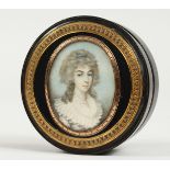 A GEORGIAN EBONY CIRCULAR BOX, the top painted with a portrait of a young lady in a white lace