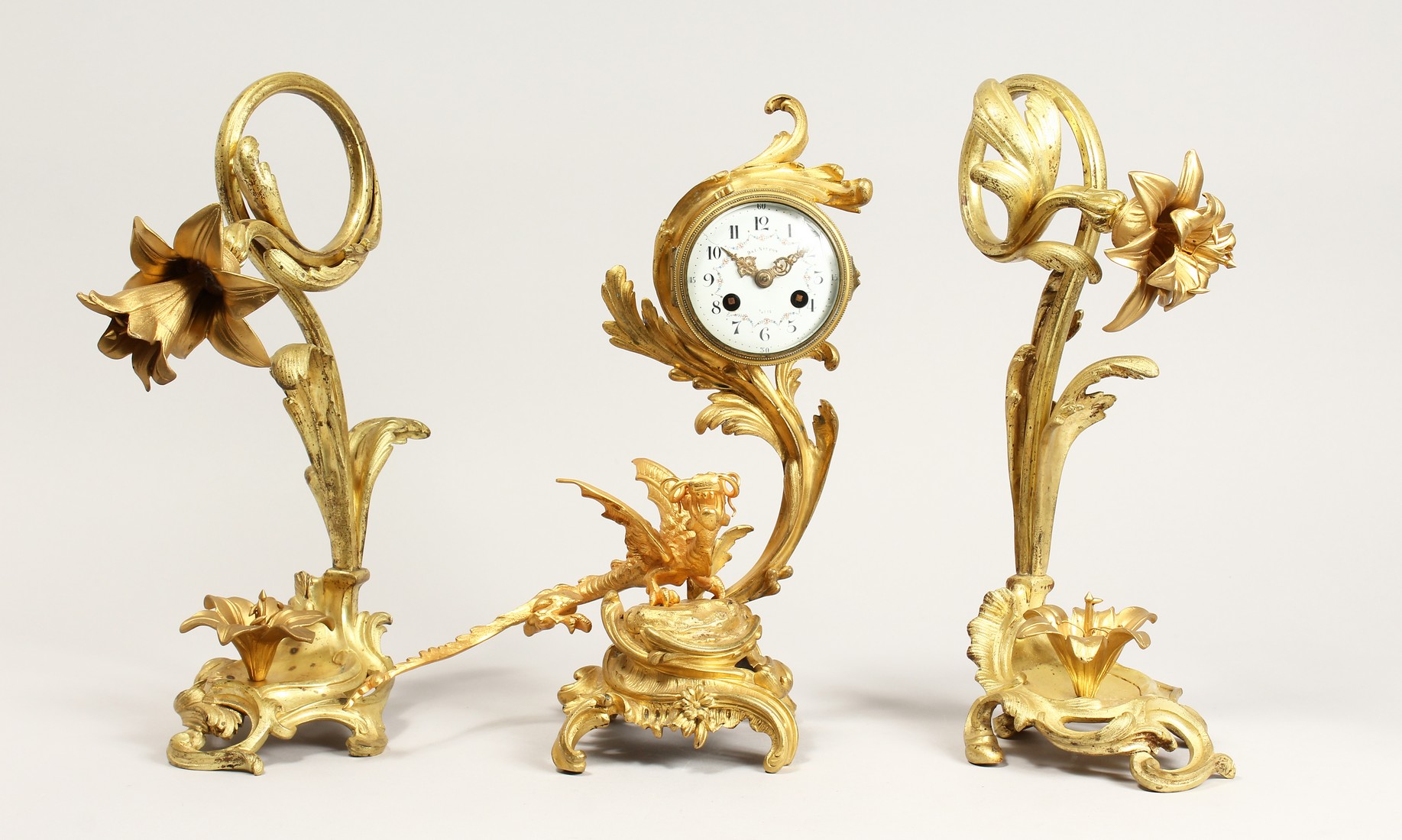 A GOOD FRENCH THREE PIECE ORMOLU CLOCK SET, with drum movement by DAI NIPPON, Paris, with acanthus