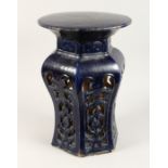 A CHINESE POTTERY SEAT with circular top and pierced sides. 1ft 8ins high.