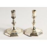 A PAIR OF CAST SILVER CANDLESTICKS 3.5ins high London 1969