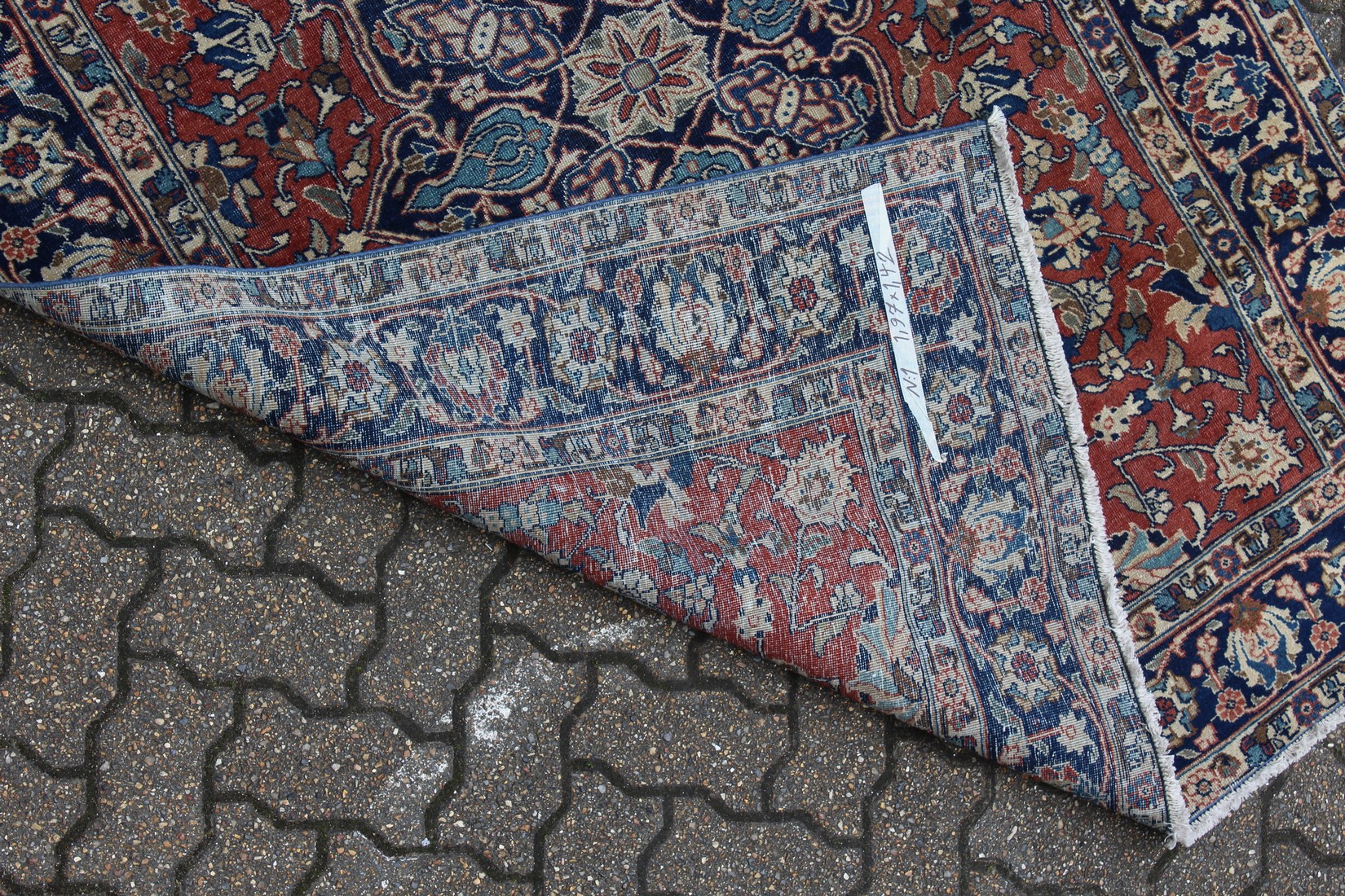 AN EARLY 20TH CENTURY PERSIAN RUG, claret ground with stylised decoration, within a blue ground - Image 2 of 2