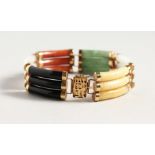 A CHINESE 14CT GOLD MULTI COLOURED JADE BRACELET.