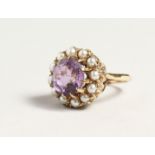 A GOLD CIRCULAR AMETHYST AND PERAL CLUSTER RING