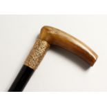 A RHINO HANDLE WALKING STICK with tablet dated May 1905. 33ins long.