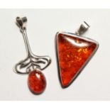 TWO SILVER AND AMBER PENDANTS