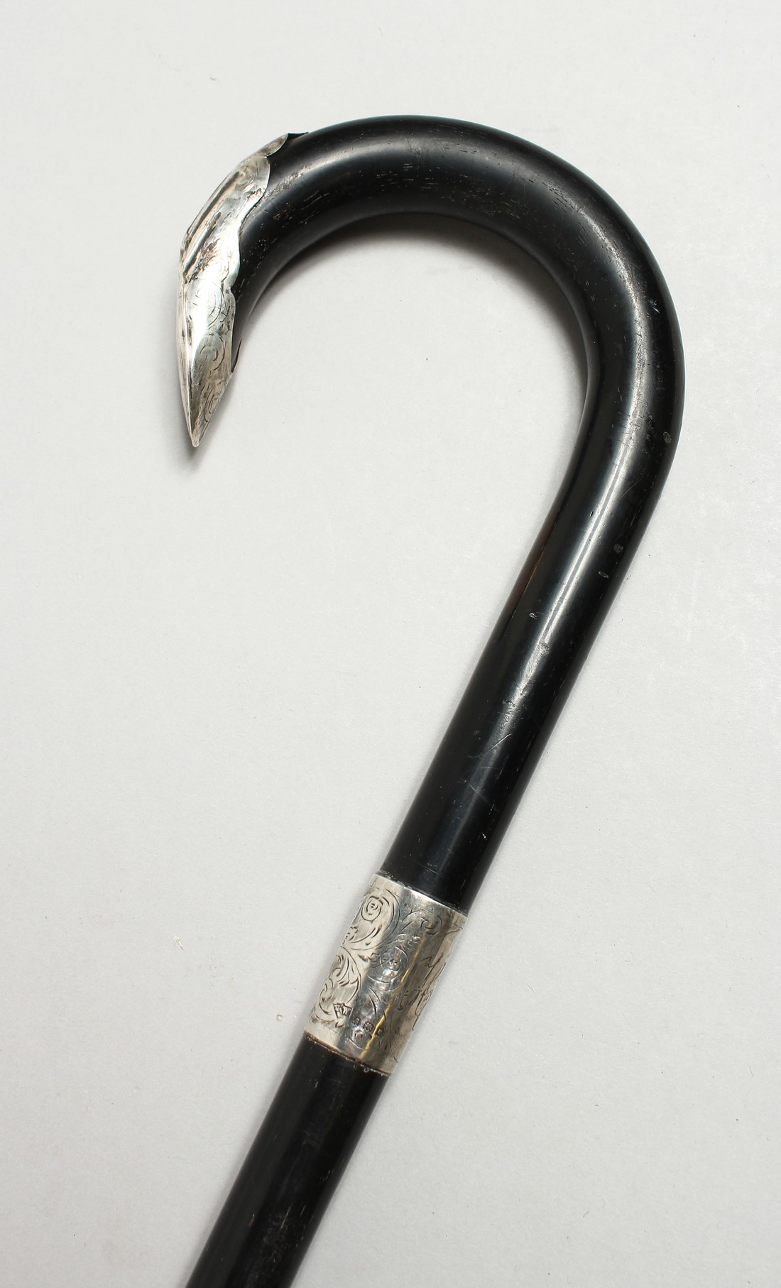 AN EBONY SILVER MOUNTED WALKING STICK, LONDON 1933. 36ins long.