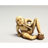 A CARVED BONE NETSUKE OF AN ONI 1.5ins