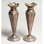 A PAIR OF SILVER VASES on circular loaded bases Birmingham 1917 6ins high.