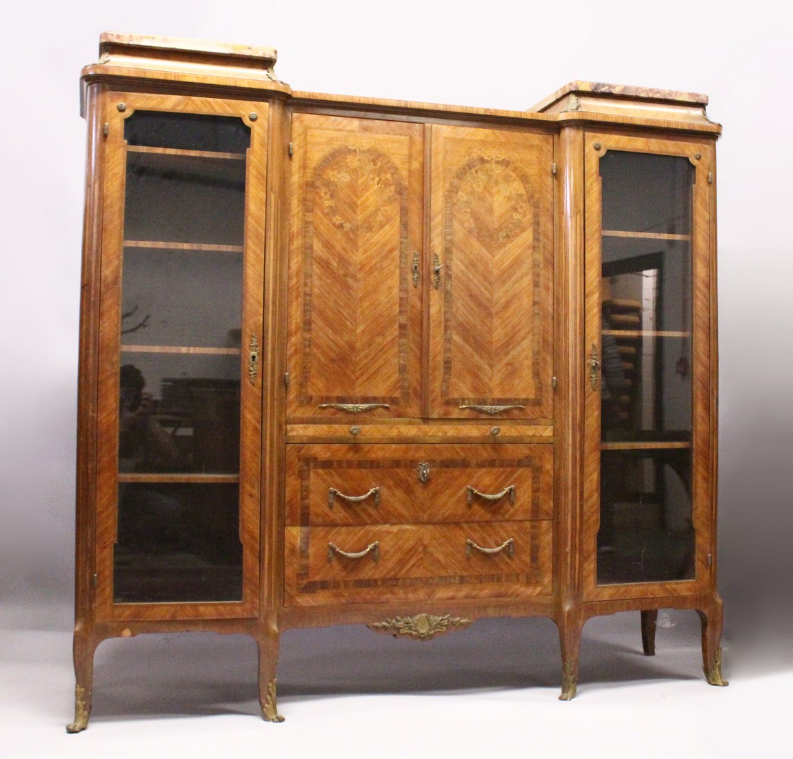 A GOOD LARGE FRENCH KINGWOOD CABINET, formed as a pair of central marquetry panel doors, over a