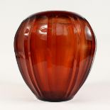 A LARGE HEAVY AMBER/ BROWN GLASS VASE. 12ins high.