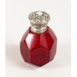A FACET CUT RUBY GLASS SCENT BOTTLE with silver top.