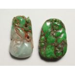 TWO CARVED STONE PENDANTS