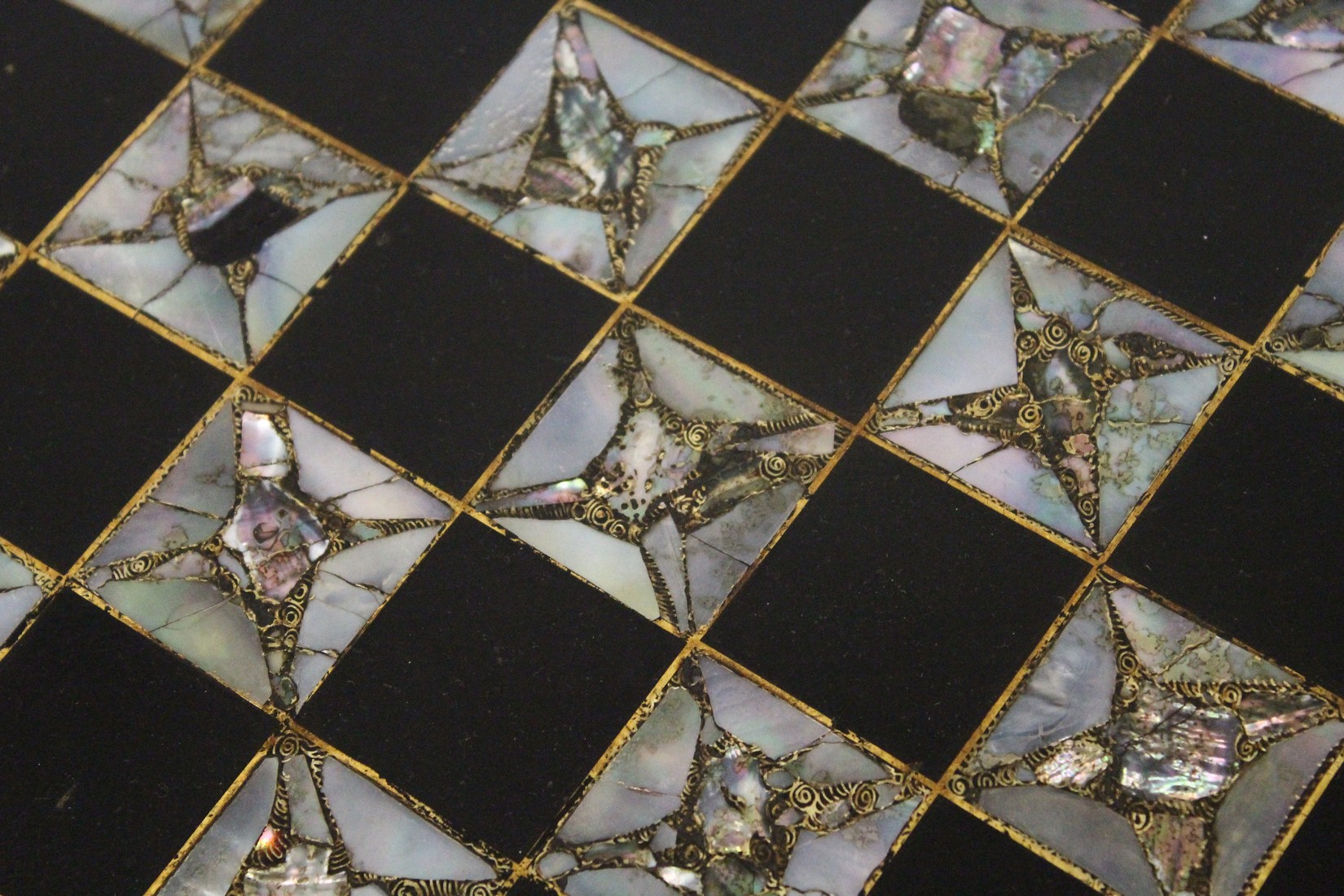 A VICTORIAN BLACK AND GILT PAPIER MACHE TILT TOP GAMES TABLE, with inlaid chess board in mother of - Image 3 of 5