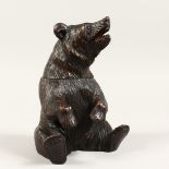 A BLACK FOREST CARVED WOOD BEAR CADDY. 8ins high.