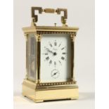 A GOOD ASPREYS BRASS CARRIAGE CLOCK with alarm. 6ins high.