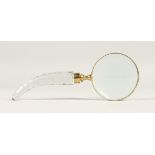 A MAGNIFYING GLASS with a cut glass handle.