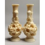 A PAIR OF FAUX IVORY PUZZLE VASES 6ins high.