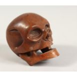 A CHINESE CARVED WOODEN SKULL Signed