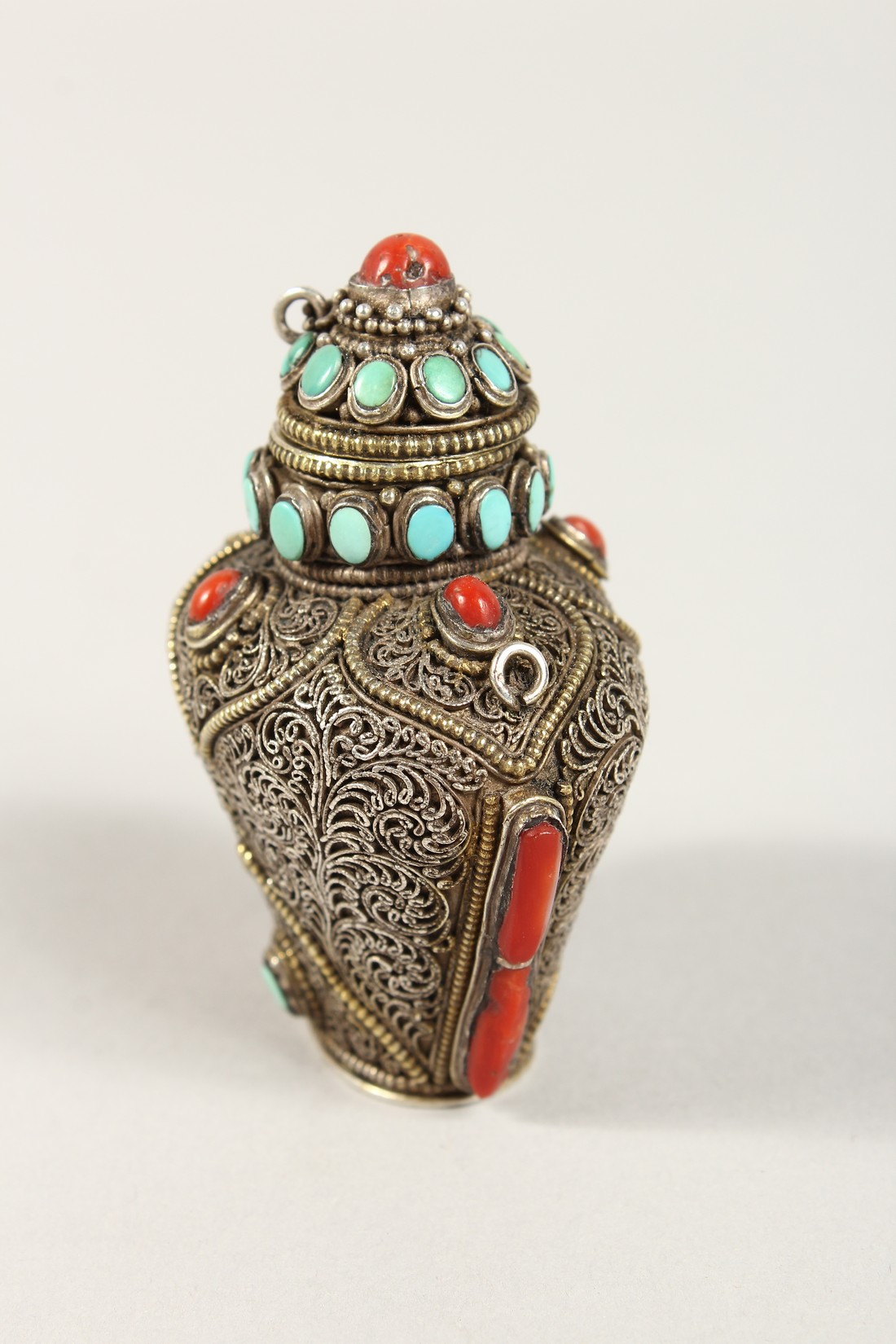 AN ISLAMIC FILIGREE SILVER SCENT BOTTLE with coral and turquoise stones. 2.5ins - Image 3 of 6