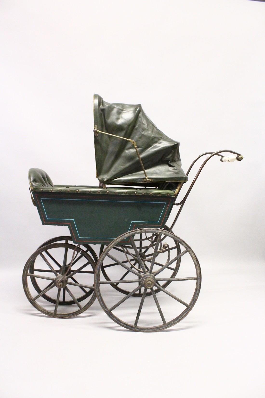 A RARE VICTORIAN METAL, WOOD AND LEATHER PRAM with folding hood, porcelain handles, wooden wheels. - Image 4 of 7