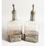 A VERY GOOD PAIR OF EUROPEAN SILVER MOUNTED ETCHED GLASS RECTANGULAR WINE BOTTLE, the glass etched