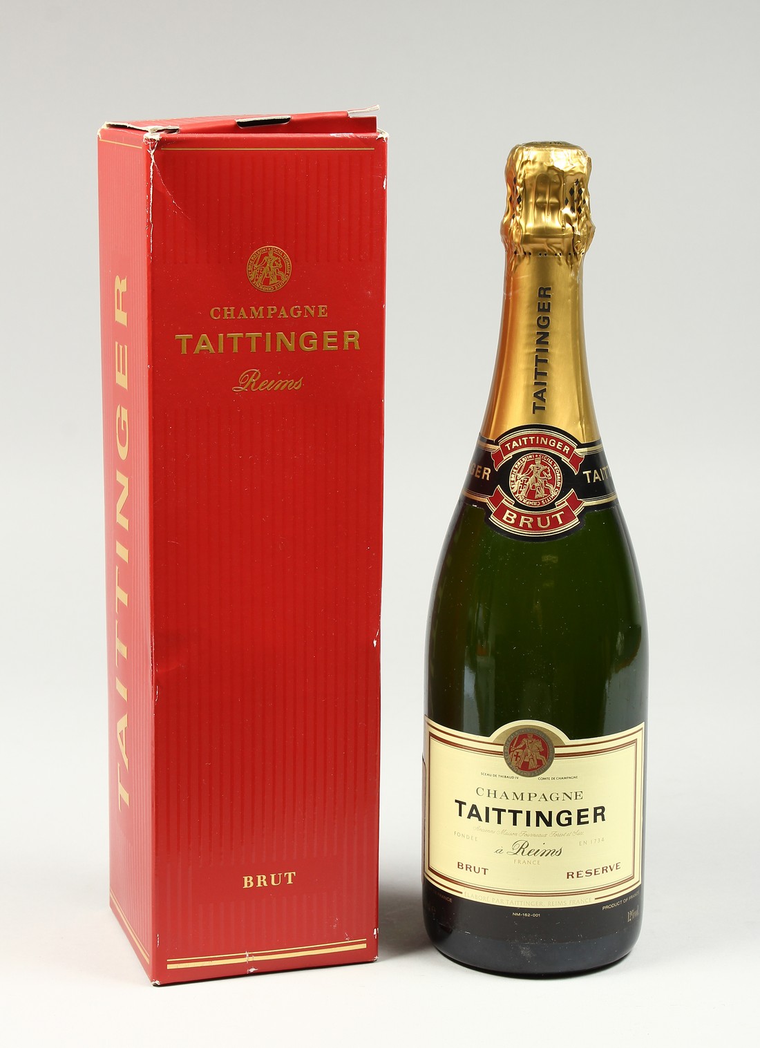 A BOTTLE OF TATTINGER CHAMPAGNE in an unopened box.