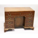 A GOOD GEORGE III MAHOGANY KNEEHOLE DESK, with plain top, brushing slide end on long drawer, three