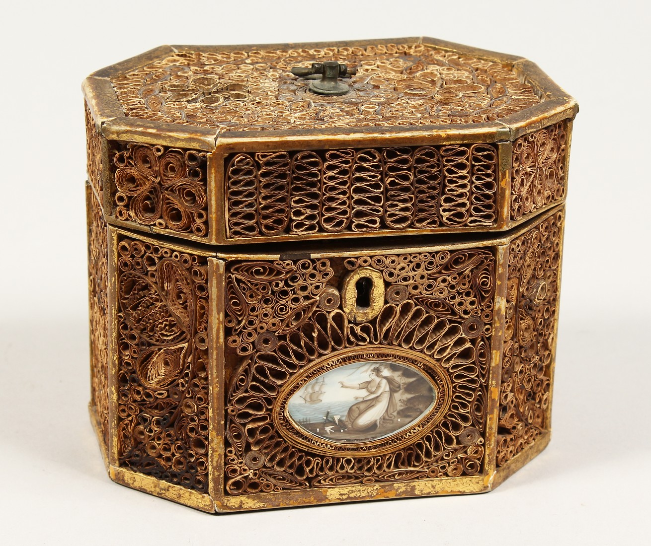 A GEORGE III ROLLED PAPER OCTAGONAL TEA CADDY inlaid with an oval. 5.5ins long.