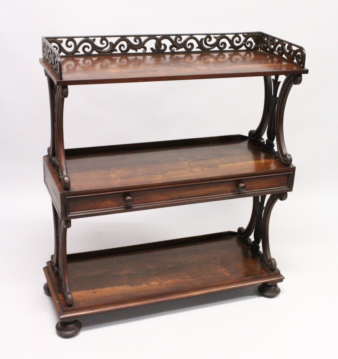 A GOOD LATE REGENCY ROSEWOOD THREE TIER WHAT-NOT, with pierced gallery, three shelves, the centre