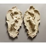A PAIR OF NOUVEAU STYLE PLAQUES with classical figures 13ins long