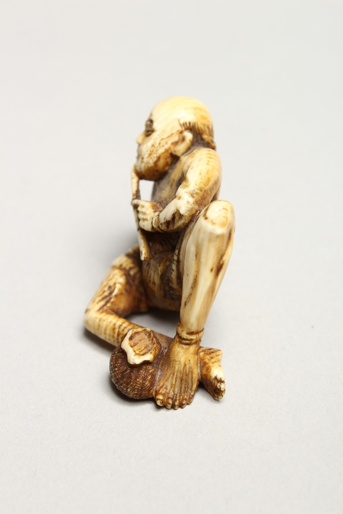 A CARVED BONE NETSUKE OF AN ONI 1.5ins - Image 4 of 6