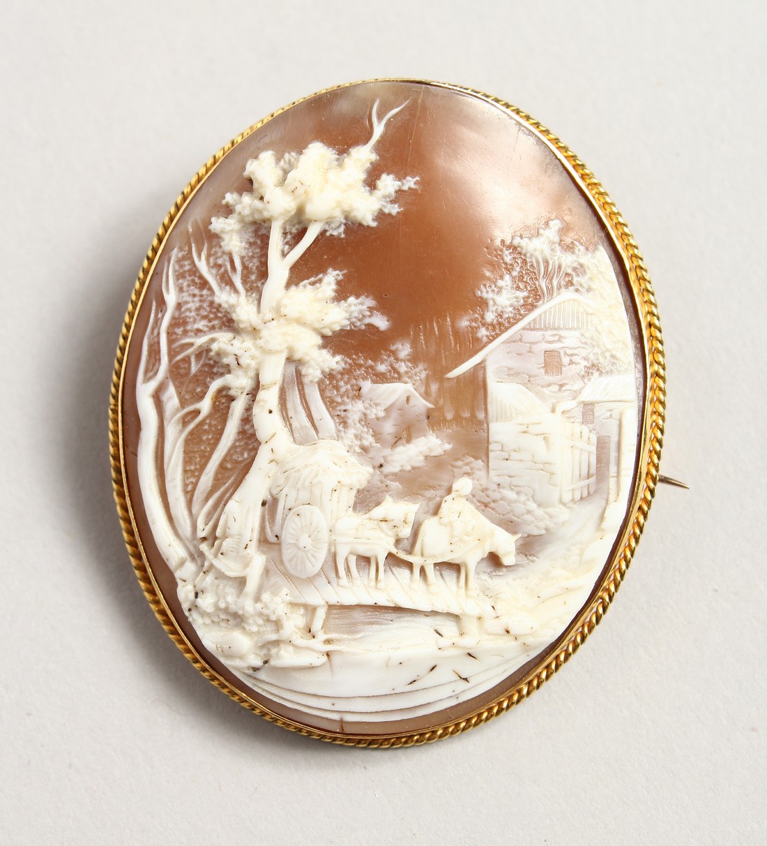 A LARGE 18CT GOLD OVAL CAMEO BROOCH, landscape, horse drawn cart.