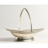 A FINE GEORGE III SILVER CAKE BASKET by HESTER BATEMAN with bead edges and swing handles. London