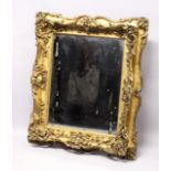 A GOOD VICTORIAN GILT FRAMED MIRROR. Mirrored panel 26ins x 22ins.