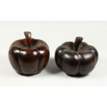 A LARGE PAIR OF CARVED WOOD PUMPKIN DOOR STOPS.