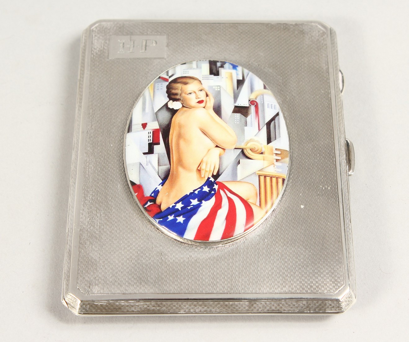 AN ENGINE TURNED SILVER CIGARETTE CASE, THE LID WITH A GLAMOUR MODEL Birmingham, 1938