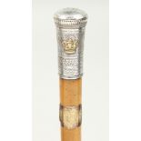 A 19TH CENTURY CEREMONIAL CANE with engraved silver top with a crown. 35ins long.