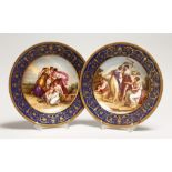 A GOOD PAIR OF VIENNA PORCELAIN PLATES,rich blue gilt borders, the centres painted with classical