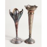TWO SILVER FLOWER VASES on circular loaded bases 7ins & 8ins high.