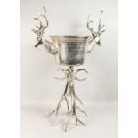 A LONG, STANDING STAG MOUNTED WINE COOLER on plated antler legs 3ft high.