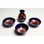 FOUR SMALL PIECES OF MOORCROFT a vase 3.5ins high and 3 bowls 3.5ins diameter.