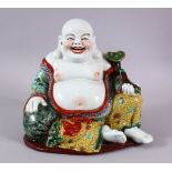 A CHINESE PORCELAIN BUDDHA, holding a scepter.