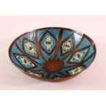 A GOOD SYRIAN ENAMEL BOWL, with floral decoration and a turquoise ground, 14cm