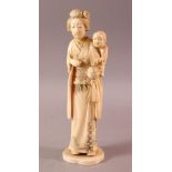 A LARGE JAPANESE MEIJI PERIOD CARVED IVORY OKIMONO - MOTHER AND CHILD, the mother stood holding