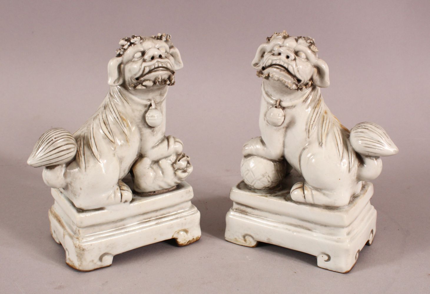 A CHINESE BLANC DE CHINE PORCELAIN FIGURES OF DOGS, formed as incense holders, 13cm